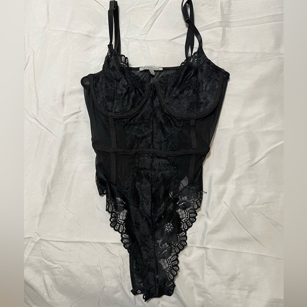 Black body suit if you like to show a title bit of Cleavage